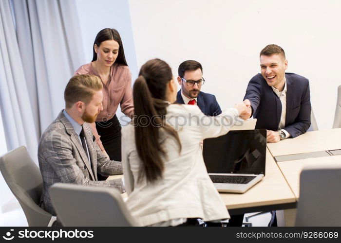 Business people shaking hands finishing up a meeting in modern office