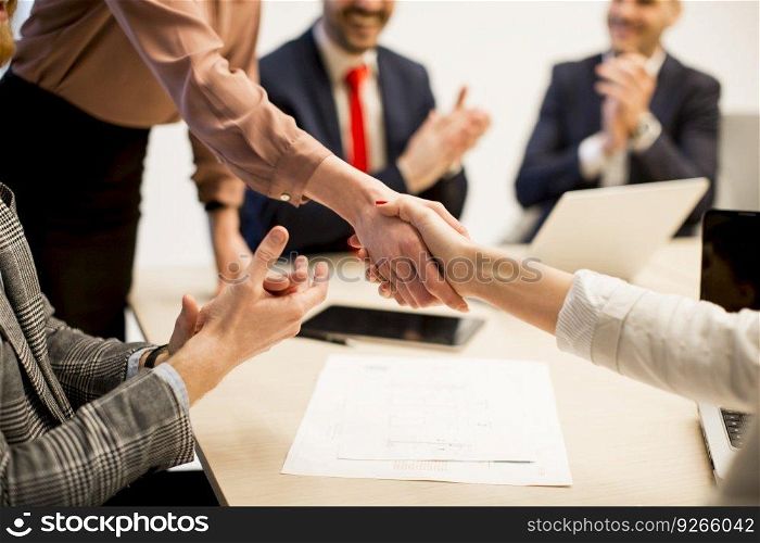 Business people shaking hands finishing up a meeting  in office