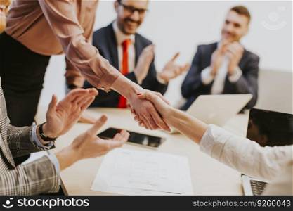 Business people shaking hands finishing up a meeting in office