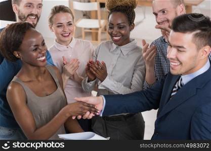 Business people shaking hands, finishing up a meeting multi-ethnic group of people
