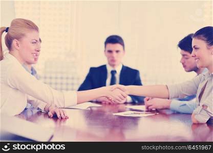 business people shaking hands make deal and sign contract in bright modern office
