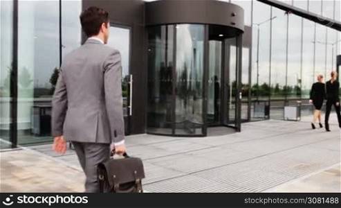 Business people shaking hands outdoor office building and walking inside together