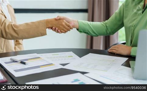Business People shaking hands with unrecognizable colleague during successful making a deal meeting in the boardroom