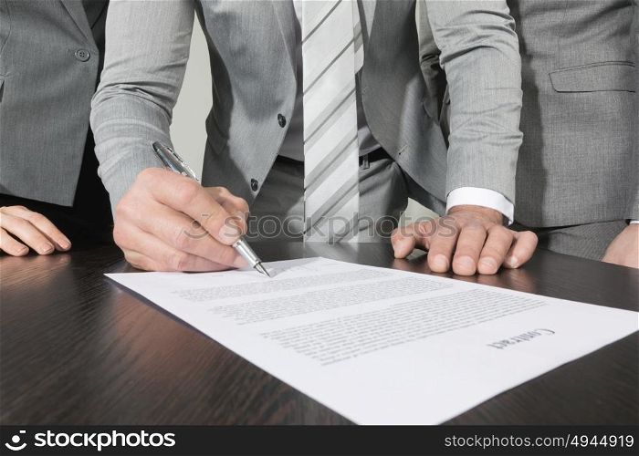 Business people sign contract. Group of business people sign a contract finishing deal