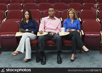 Business people sitting in auditorium