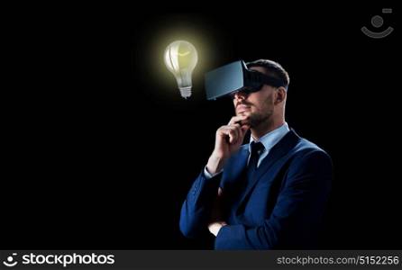 business, people, startup idea, augmented reality and modern technology concept - businessman in virtual headset looking at lightbulb over black background. businessman in virtual reality headset over black
