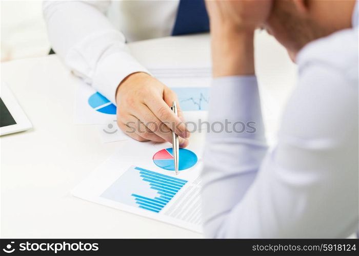 business, people, statistics and fail concept - close up of businessman hands showing chart to other anxious man man at office