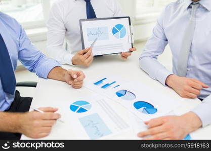 business, people, statistics and teamwork concept - close up of businessman hands with clipboard pointing pen to chart at office