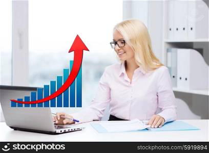 business, people, statistics and technology concept - smiling businesswoman with laptop computer, papers and growing chart sitting in office