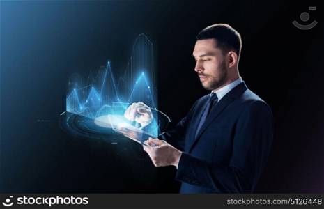 business, people, statistics, economics and modern technology concept - businessman in suit working with transparent tablet pc computer and virtual charts projection over black background. businessman with tablet pc and virtual charts