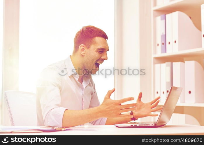 business, people, stress, fail and technology concept - angry businessman with laptop computer and papers shouting in office