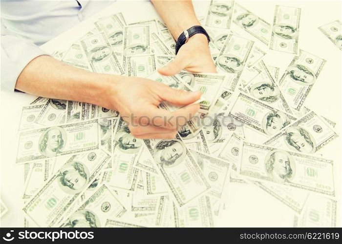 business, people, success and fortune concept - close up of male businessman hands with dollar money