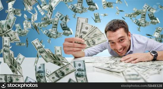 business, people, success and fortune concept - happy businessman with heap of dollar money over blue background
