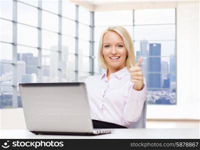 business, people, success, gesture and technology concept - smiling businesswoman or student showing thumbs up with laptop computer in office