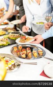 Business people take buffet appetizers at company event