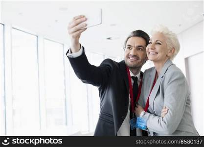 Business people taking selfie in convention center