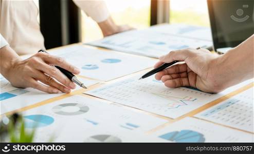 Business People Talking Discussing with coworker planning analyzing financial document data charts and graphs in Meeting and successful teamwork Concept