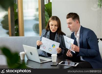 Business people talking in office using digital tablet and computer 