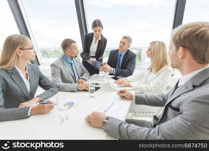 Business people team at meeting. Business people team at meeting working documents together in office
