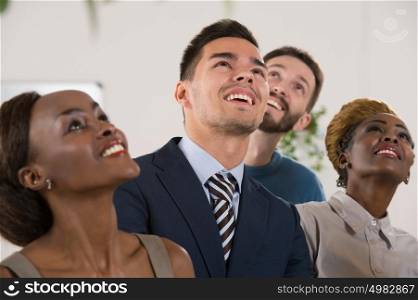 Business people team of diverse ethnicity looking up and dreaming