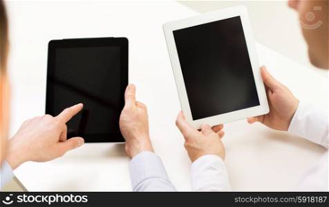 business, people, technology, advertisement and teamwork concept - close up of businessman hands with tablet pc computer blank screens at office