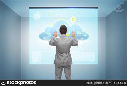 business, people, technology and cloud computing concept - businessman working with virtual screen over gray room background from back