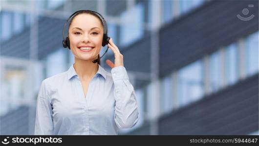 business, people, technology and communication concept - happy asian female helpline operator in headset over city office building background