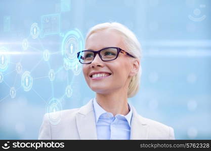 business, people, technology and communication concept - young smiling businesswoman in eyeglasses looking to network hologram outdoors