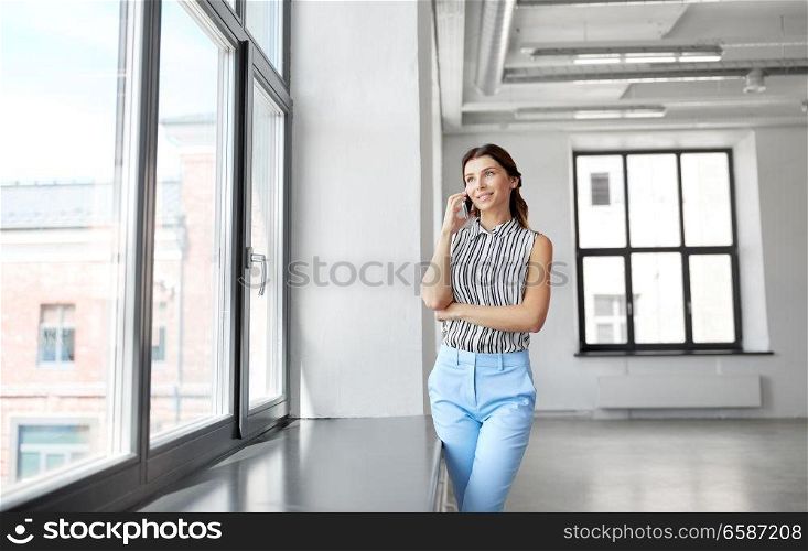 business people, technology and corporate concept - businesswoman or realtor calling on smartphone at office. businesswoman calling on smartphone at office