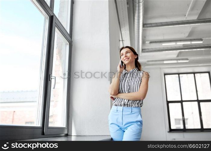 business people, technology and corporate concept - businesswoman or realtor calling on smartphone at office. businesswoman calling on smartphone at office