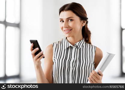 business people, technology and corporate concept - businesswoman or realtor with smartphone and folder at office. businesswoman with smartphone and folder at office