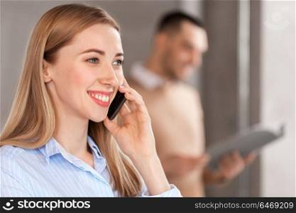 business people, technology and corporate concept - close up of businesswoman calling on smartphone at office. businesswoman calling on smartphone at office