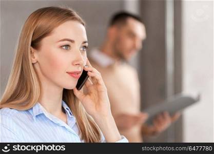 business people, technology and corporate concept - close up of businesswoman calling on smartphone at office. businesswoman calling on smartphone at office. businesswoman calling on smartphone at office