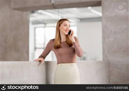 business people, technology and corporate concept - happy smiling businesswoman calling on smartphone at office. businesswoman calling on smartphone at office
