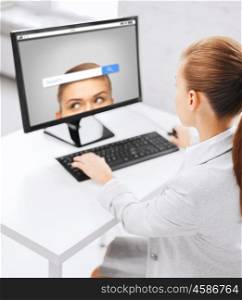 business, people, technology and education concept - businesswoman or student girl with internet browser search bar on computer screen sitting at office table