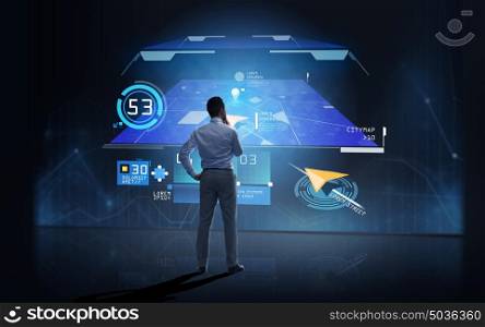 business, people, technology and innovation concept - businessman looking at gps navigator map on virtual screen over dark background from back. businessman looking at gps navigator map over dark