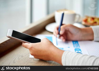 business, people, technology and lifestyle concept - woman with smartphone chart at cafe