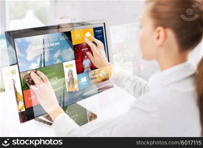 business, people, technology and mass media concept - woman with web pages on computer touchscreen in office