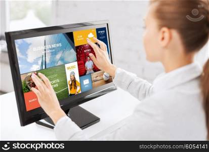 business, people, technology and mass media concept - woman with web pages on computer touchscreen in office