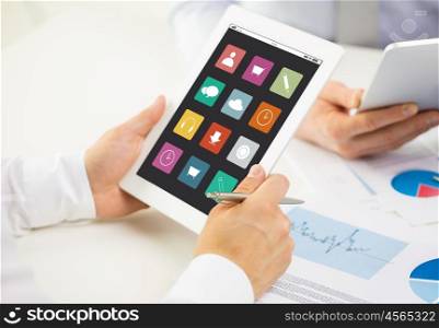 business, people, technology and media concept - close up of businessman hands with menu icons on tablet pc computer screen at office