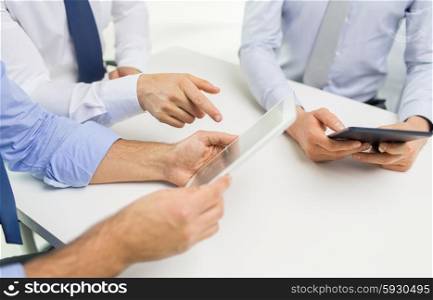 business, people, technology and teamwork concept - close up of businessman hands with tablet pc computer at office