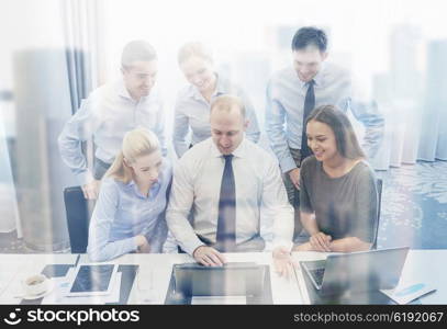 business, people, technology and teamwork concept - smiling business team with laptop computers working in office