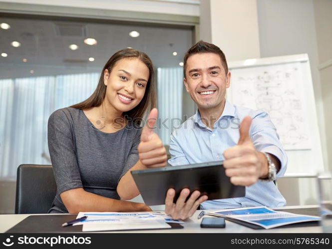 business, people, technology and teamwork concept - smiling businessman and businesswoman with tablet pc computer showing thumbs up gesture meeting in office