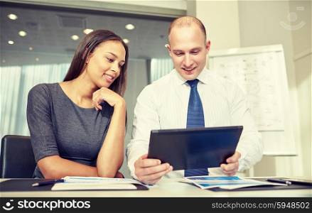 business, people, technology and teamwork concept - smiling businessman and businesswoman with tablet pc computer meeting in office