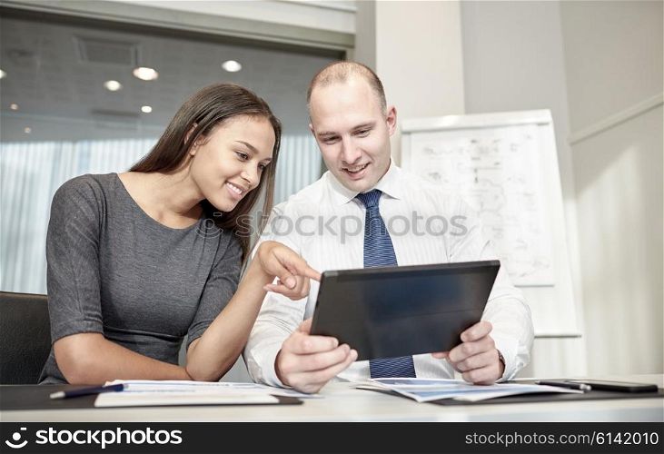 business, people, technology and teamwork concept - smiling businessman and businesswoman with tablet pc computer meeting in office