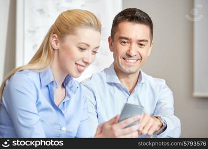 business, people, technology and teamwork concept - smiling businessman and businesswoman with smartphones meeting in office