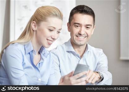 business, people, technology and teamwork concept - smiling businessman and businesswoman with smartphones meeting in office
