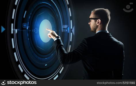 business, people, technology and virtual reality concept - businessman in suit and glasses pointing finger to projection over black background. businessman pointing finger to