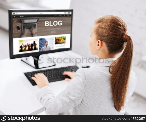 business, people, technology, blogging and education concept - businesswoman or student girl with internet blog page on computer screen sitting at office table