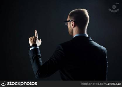 business, people, technology, choice and virtual reality concept - businessman in suit and glasses pointing finger to something invisible